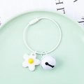 Macro shot of white silicone flower pendant and metal bell on steel wire keychain - Wire Ring + Soft Flower + 22mm Bell / White