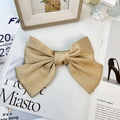 Detailed view of elegant champagne gold satin bow hair clip with smooth glossy texture - Khaki (Spring Clip)