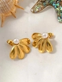 Close-up of golden three-petal flower earrings with a white pearl center on beach seashells - Flower Pearl Stud Earrings