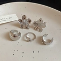 Detailed set of silver floral earrings and minimalist rings on a ceramic plate - Silver Teardrop 5-Piece Set