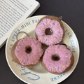 Pink handmade wool felt donut keychains with sprinkles on a decorative plate - Pink Donut Trio
