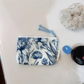 Close-up of floral cotton pouch with blue zipper pull and 'simple wish' label - Tie-dye Floral