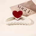 Detail of cream shark clip with red heart accent on a minimalist fashion background - Heart Hollow Semicircle / Creamy White