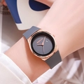 Minimalist women's watch with grey silicone strap and rose gold case on a wrist - Gray
