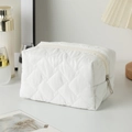 Quilted white cosmetic bag with large diamond stitching and a secure silver zipper - White