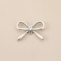 Detail view of silver bow-shaped charm with central zircon and metallic texture - Center Zirconia Bow (PJ0505) / Silver