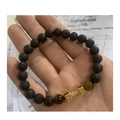Beaded lava stone bracelet with tiger eye beads and golden dumbbell charm on wrist - Lava Tiger Eye Gold