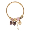 Golden twisted wire bracelet with purple crystal bow, key, and tree of life charms - Purple