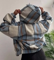 Detail view of the back of a thick fleece-lined plaid jacket with hood and elastic hem - S / Sky Blue