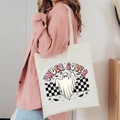 Halloween Under Cover ghost print white canvas tote bag carried by a model - Under Cover