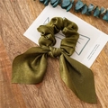 Olive green satin silk scrunchie with elegant bow tie on a wooden background - Dark Green