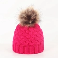 Close-up of baby winter knit hat with rose red cable pattern and brown faux fur pompom - 0-12 Months / Rose Red
