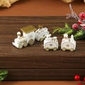 Close-up of white and gold wooden Christmas train with snowman and bear figurines - White