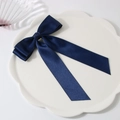 Navy blue satin bow hair clip with long ribbons on a white decorative ceramic plate - Navy Blue