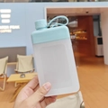 Flat minimalist square water bottle with light blue lid and portable strap handle - 450ml / Blue