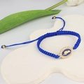 Handmade woven blue bracelet featuring a gold San Judas Tadeo pendant with white zircons - Blue