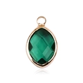 Close-up of emerald green marquise cut glass pendant with gold plated metal border - Gold - May