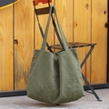 Minimalist canvas tote bag in army green color hanging on a metal chair - Green