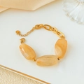 Chic stainless steel chain bracelet with irregular amber resin beads on a gold tray - Stainless Steel Marble Pattern Bracelet / Light Hazel