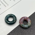 Close-up of polished natural stone abacus beads in dark green and mixed moss colors - India Agate