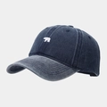 Close-up of small bear embroidery on vintage washed navy denim baseball cap fabric - Navy Blue