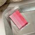 Close-up of matte pink gradient metal hair pins organized in a transparent PVC bag - Pink