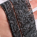 2mm 3mm snowflake obsidian beads strands held in hand showing natural stone textures - Snowflake Obsidian