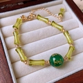 Macro detail of beaded bracelet with green bamboo glass, gold accents and scripture bead - Yellow Green Bamboo-Scripture