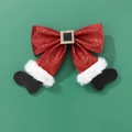 Dettaglio di un fiocco di Natale rosso glitterato con stivali di Babbo Natale su sfondo verde - Rosso