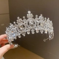 Princess style silver tiara crown with clear crystals and rhinestones held in hand - Acanthus Gemstone Tiara / Silver