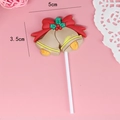 Christmas cake topper featuring festive red bells with holly leaves and bow tie decoration - Bells