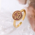 Detail of gold-plated Hamsa hand ring with pink zircon pavé on white marble surface - Adjustable Open / Red