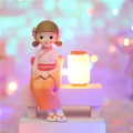 Pink and orange kimono girl figurine sitting on a white bench with glowing lantern - Style 1136-6 Orange Light