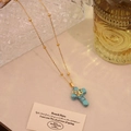 Detail of turquoise cross pendant on a gold chain with butterfly accent and vintage props - Turquoise Butterfly Style (8# Turquoise)