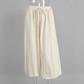 Close-up of elastic drawstring waistband on beige cotton loose-fit lantern pants - S / Apricot