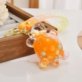 Detailed macro view of orange liquid-filled turtle keychain with glitter and Bubble strap - Jelly Bean Orange