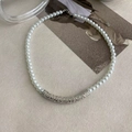 Detail of French style pearl necklace with textured silver metal accents and chain extender - Silver