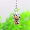 Macro shot of silver wire wrapped mushroom pendant with natural speckled stone texture - Dalmatian Stone Silver-tone