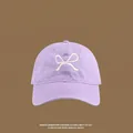 Detailed close-up of light purple cotton sun hat with white bow embroidery on front - Front Bowknot Embroidery Baseball Cap / Purple