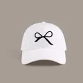 White baseball cap featuring elegant black bow embroidery and a six-panel classic design - Hard Top Bow Baseball Cap Style / White