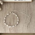 Detail of bohemian braided belt with white textured beads and silver metal spacers - Irregular White Bead Series - 136cm