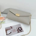 Light grey pebble leather envelope crossbody bag with gold chain and metal buckle - Gray