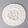 Close-up of white crochet beret featuring delicate hollow floral knit patterns - White