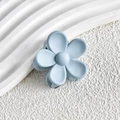 Macro detail of a light blue matte flower hair claw clip on a white stone background - Light Sky Blue