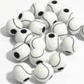Macro shot of white acrylic sports beads for jewelry making showing soccer ball details - 12mm Tennis White Background Black Line