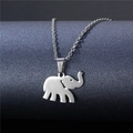 Minimalist silver elephant pendant necklace in stainless steel shown on a textured display - Elephant Silhouette