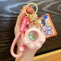 Pink cat paw sunset lamp keychain with silicone wrist strap and golden keyring - Pink