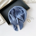 Artistic display of a blue pleated silk scarf on a tray with decorative props and card - 70*70cm / Pleated Light Blue