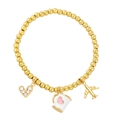 Beaded gold bracelet with heart, coffee mug and airplane charms for travel style - White