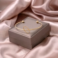 Minimalist gold knot cuff bracelet with central ring detail and metal bead accents - Geometric Circle Style (S275-1)